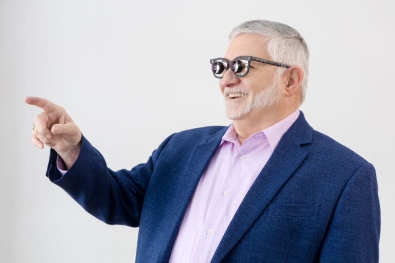 Man wearing low vision glasses pointing